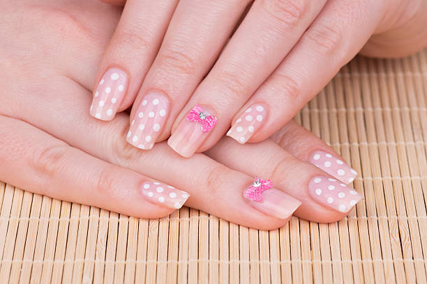 Polka dot with bow tie nail design