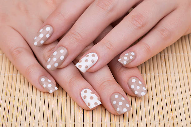 White cream polka dot nail design